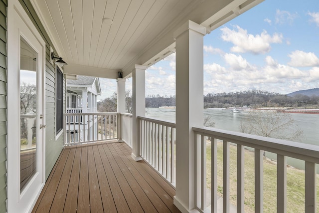 wooden deck with a water view