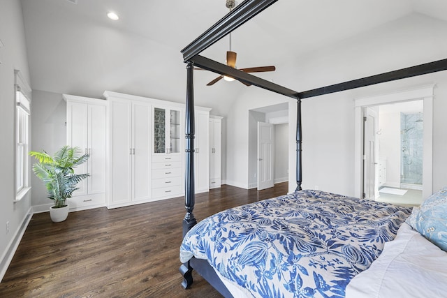 bedroom featuring dark wood-type flooring, ceiling fan, ensuite bathroom, and lofted ceiling