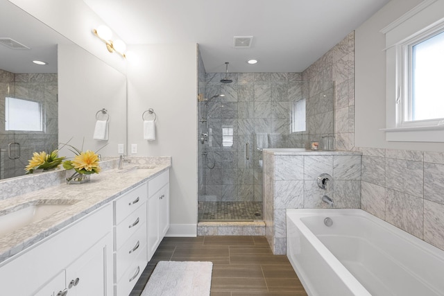 bathroom featuring vanity and shower with separate bathtub