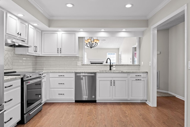 kitchen with stainless steel appliances, a sink, white cabinetry, and under cabinet range hood