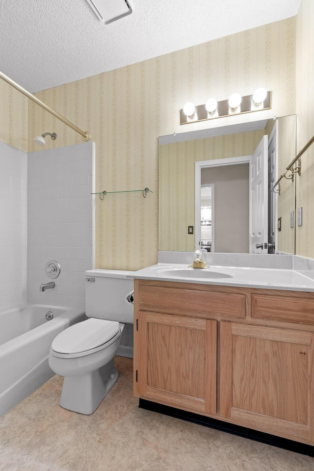 full bathroom with tub / shower combination, a textured ceiling, vanity, and wallpapered walls