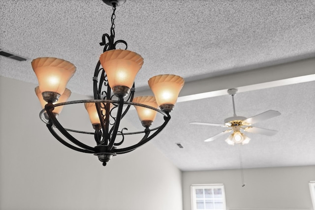 room details with ceiling fan and a textured ceiling