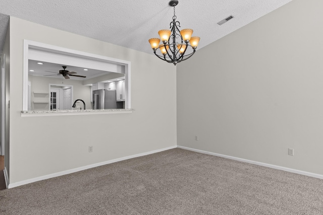 empty room featuring baseboards, visible vents, a textured ceiling, carpet flooring, and a sink