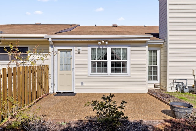 doorway to property with a patio and fence