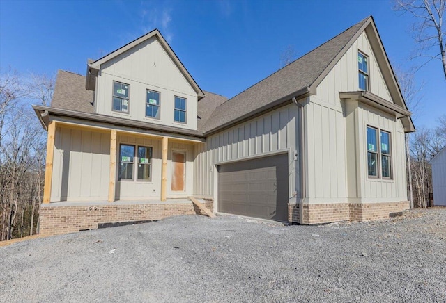 view of front facade with a garage and covered porch