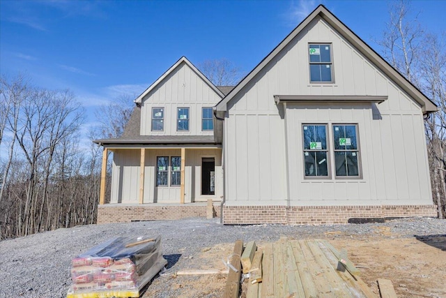 rear view of property featuring covered porch