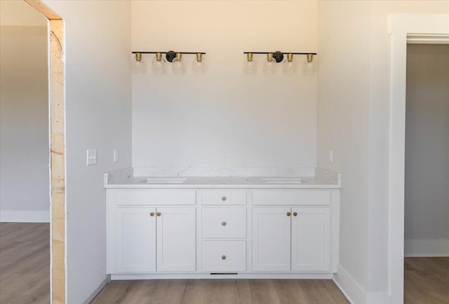 bathroom with vanity and hardwood / wood-style floors