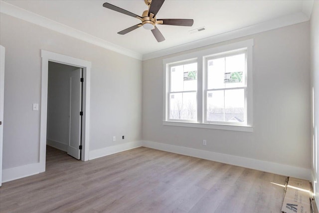 empty room with crown molding, light hardwood / wood-style floors, and ceiling fan