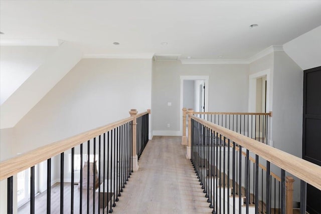 hall with ornamental molding and light wood-type flooring