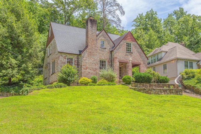 tudor-style house with a front yard