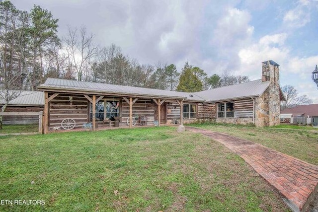 log home featuring an outdoor structure