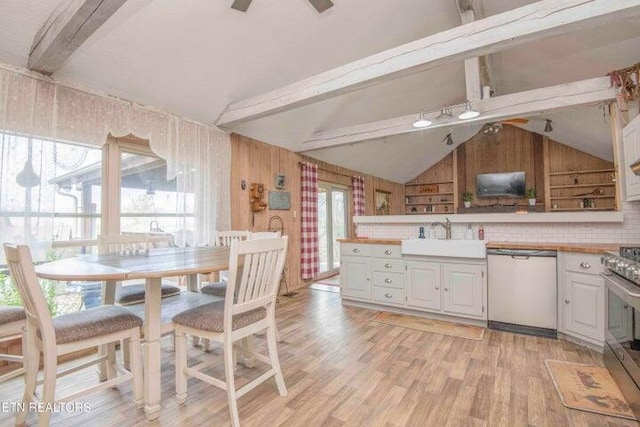 kitchen featuring sink, white cabinets, lofted ceiling with beams, and dishwashing machine