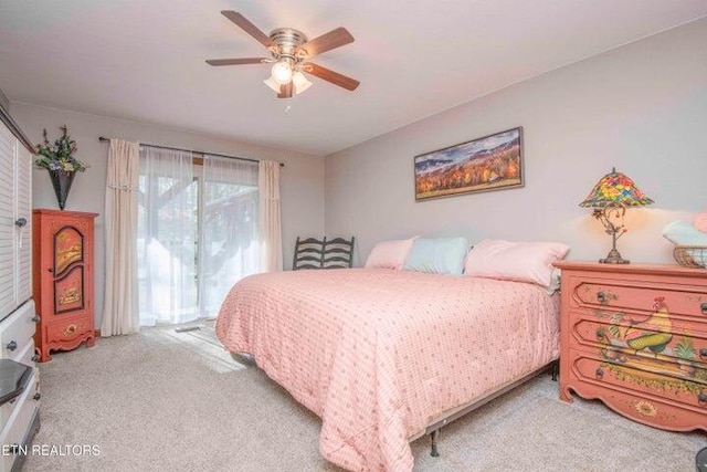 bedroom with ceiling fan and light colored carpet