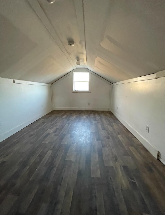 bonus room featuring dark hardwood / wood-style flooring and lofted ceiling