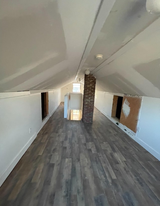 additional living space with lofted ceiling and dark hardwood / wood-style floors