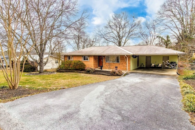 ranch-style house with a carport and a front yard