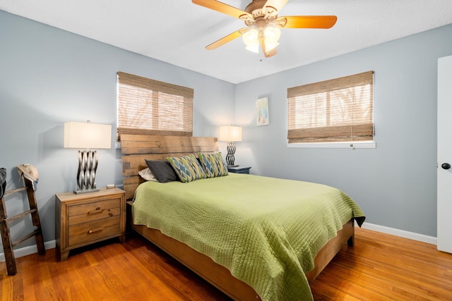 bedroom featuring hardwood / wood-style floors and ceiling fan