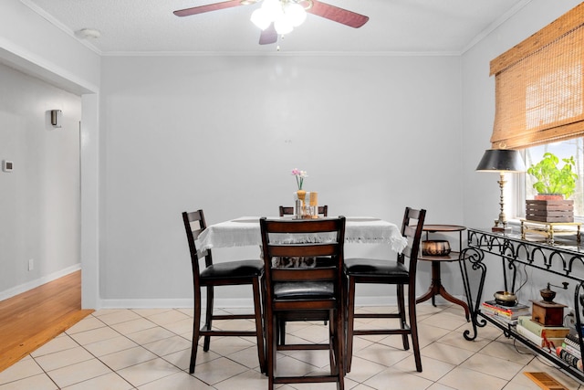 dining room with crown molding, ceiling fan, a textured ceiling, and light tile patterned floors