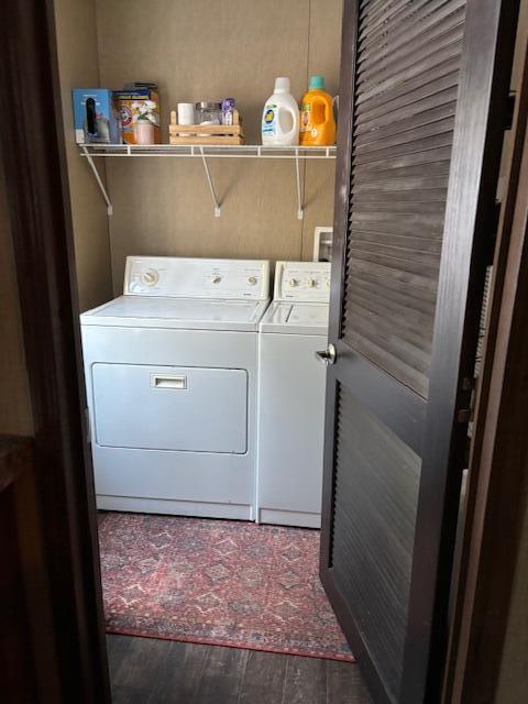 washroom with dark wood-type flooring and washing machine and clothes dryer