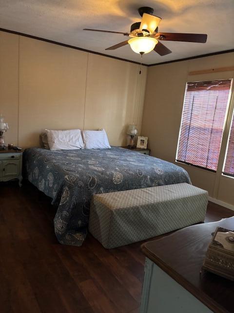 bedroom with ceiling fan and dark hardwood / wood-style flooring