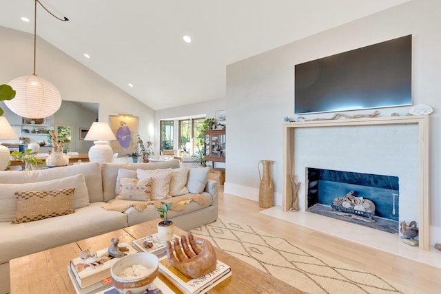 living room featuring light hardwood / wood-style flooring and high vaulted ceiling