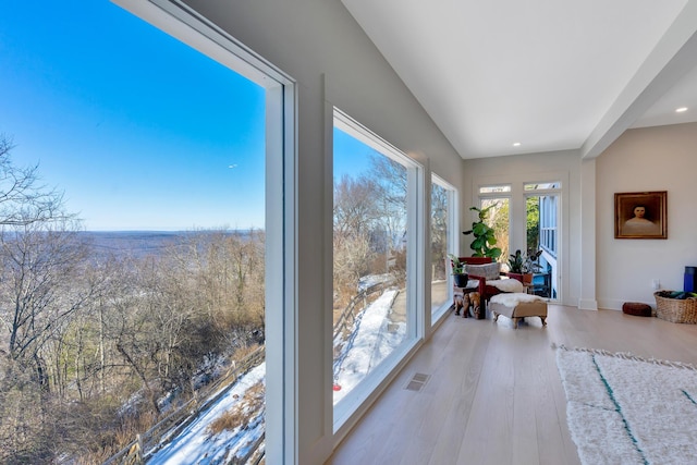 sunroom / solarium featuring vaulted ceiling