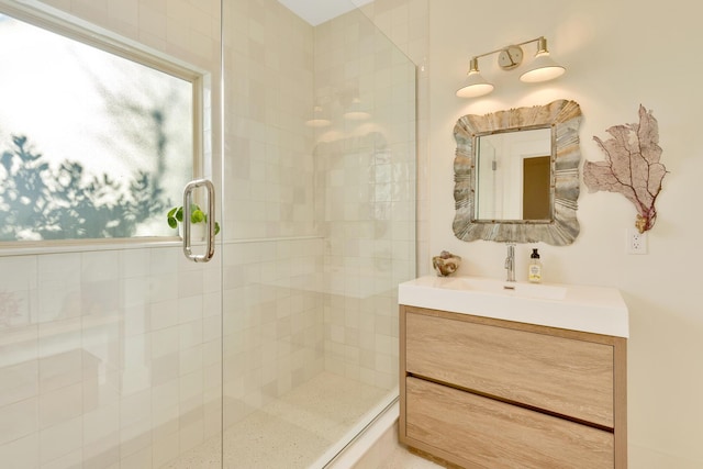 bathroom featuring an enclosed shower and vanity