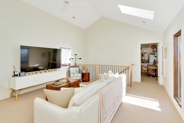 living room with light colored carpet and vaulted ceiling with skylight