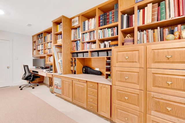 carpeted office with built in desk