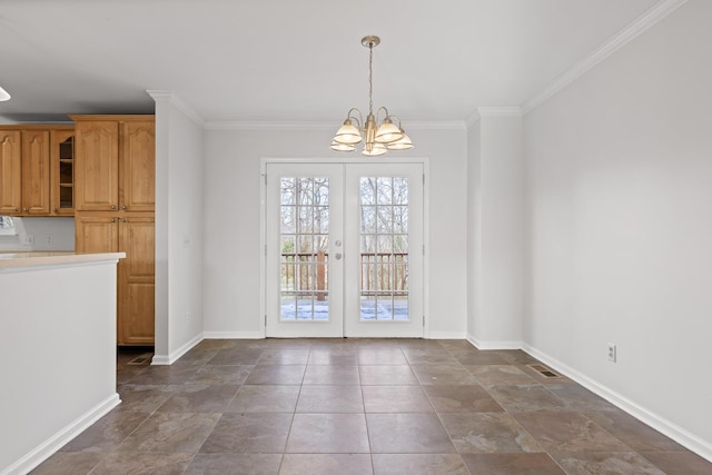 unfurnished dining area with crown molding, french doors, and a notable chandelier