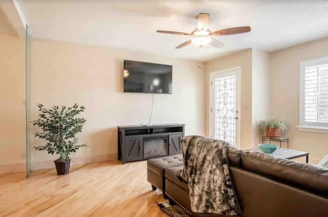 living room with ceiling fan and hardwood / wood-style flooring