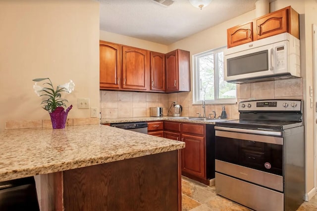 kitchen with kitchen peninsula, decorative backsplash, sink, and stainless steel appliances