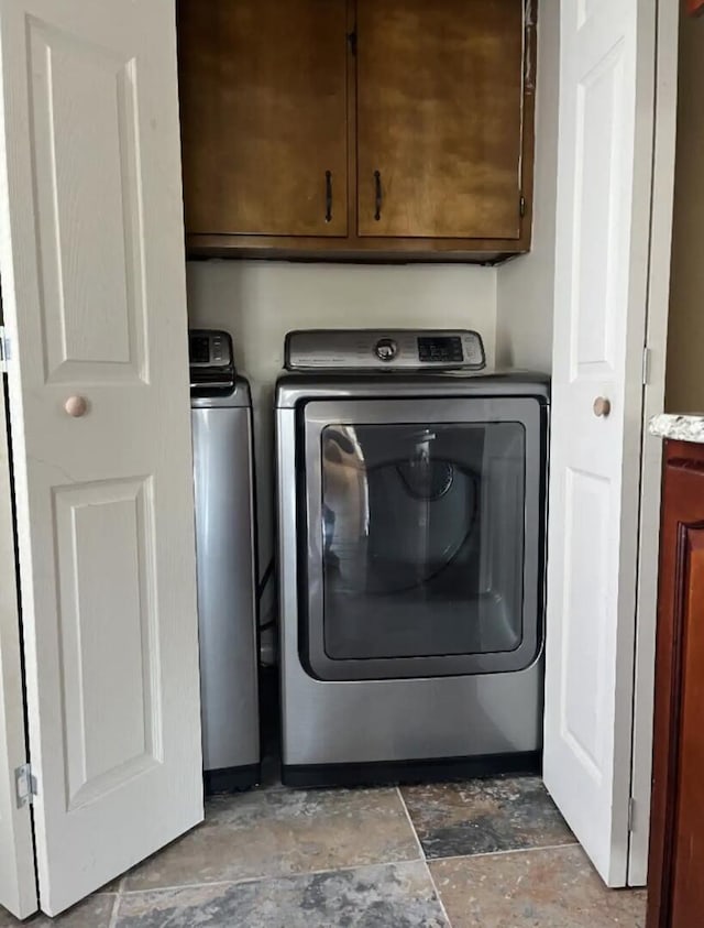 laundry area featuring independent washer and dryer and cabinets