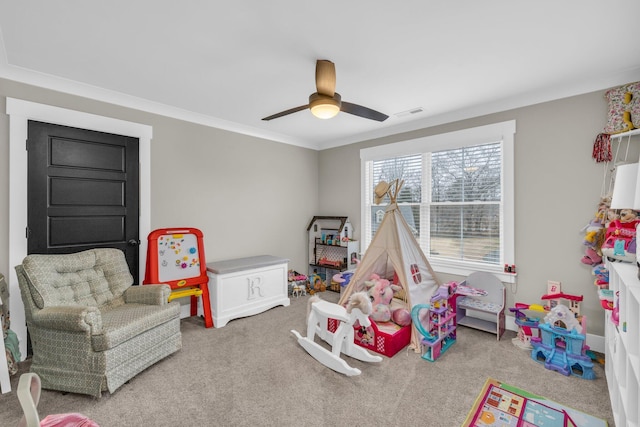 rec room featuring crown molding, ceiling fan, and carpet