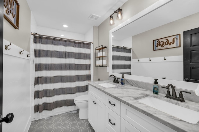 bathroom featuring vanity, toilet, tile patterned floors, and a shower with curtain