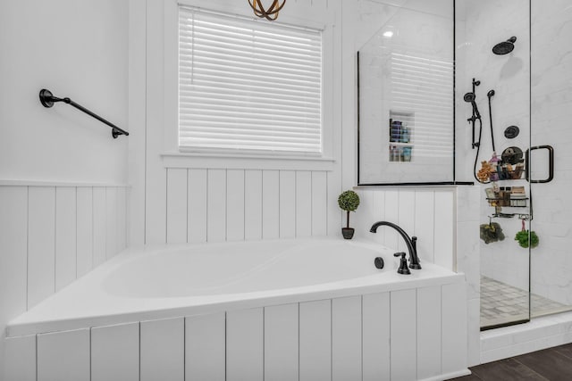 bathroom featuring hardwood / wood-style floors and plus walk in shower