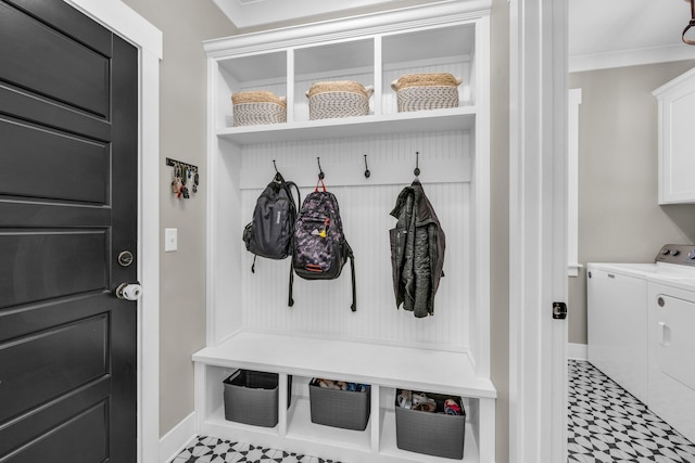 mudroom with crown molding and independent washer and dryer