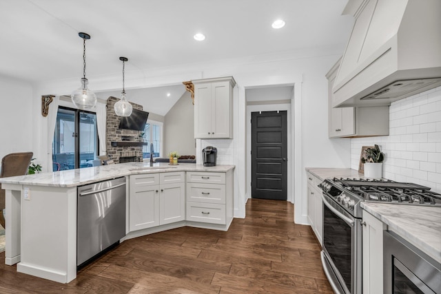 kitchen with sink, white cabinets, stainless steel appliances, and custom exhaust hood