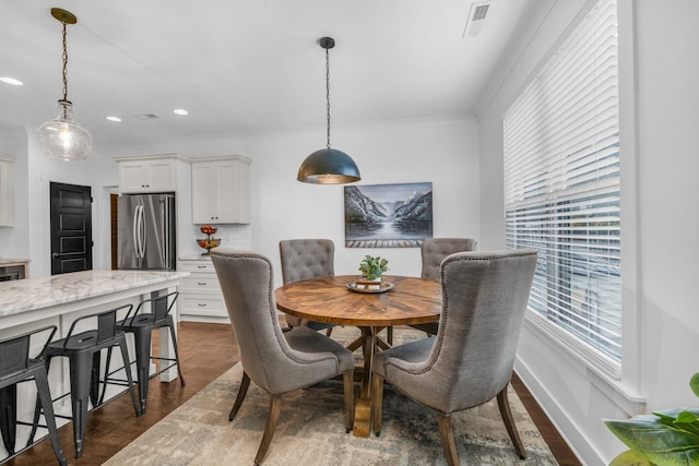 dining space featuring crown molding