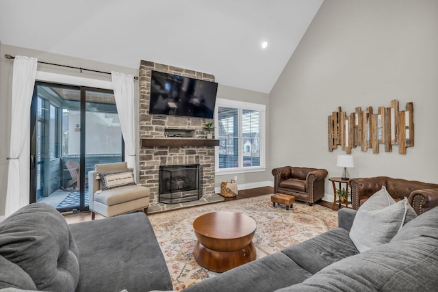 living room with high vaulted ceiling, wood-type flooring, and a fireplace