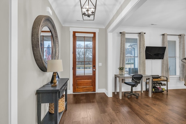 entryway with a healthy amount of sunlight, dark hardwood / wood-style floors, a notable chandelier, and ornamental molding