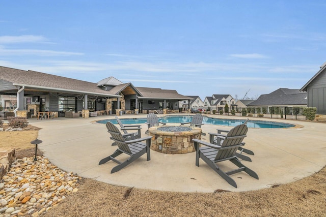 view of swimming pool featuring a patio area and a fire pit