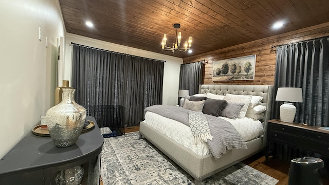 bedroom with hardwood / wood-style flooring, wood ceiling, and an inviting chandelier