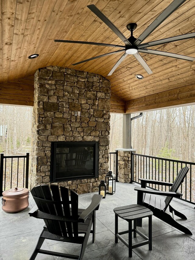 view of patio / terrace with ceiling fan and an outdoor stone fireplace