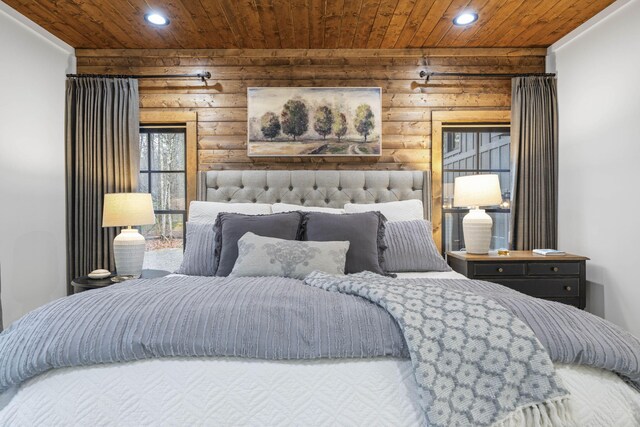 bedroom with wood ceiling and log walls