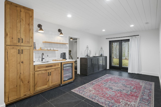 kitchen featuring sink, wood ceiling, wine cooler, dark tile patterned flooring, and decorative backsplash