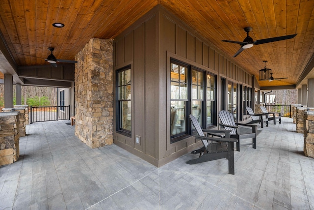 view of patio with ceiling fan and a porch