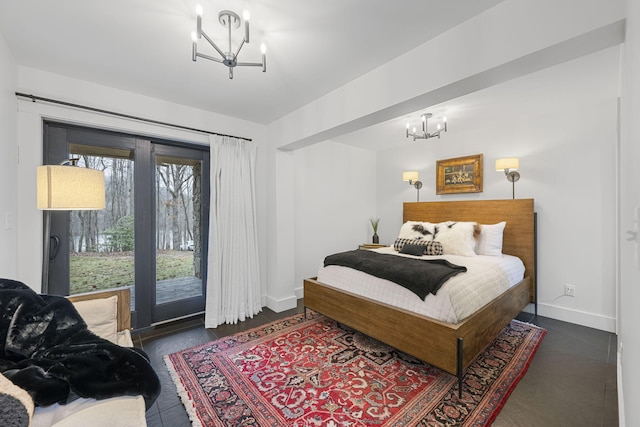 bedroom featuring a notable chandelier and access to exterior