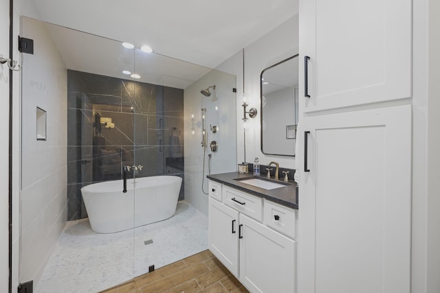 bathroom featuring vanity, plus walk in shower, and tile walls