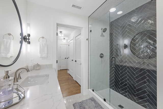 bathroom with vanity and an enclosed shower